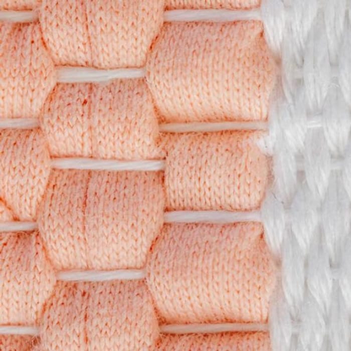 Close-up of knitted cotton fabric structures in three colours