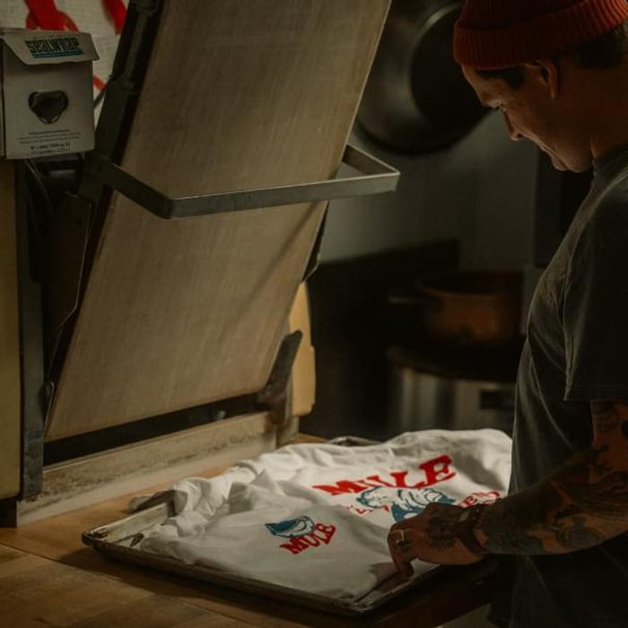 Screen printing a garment on a manual press