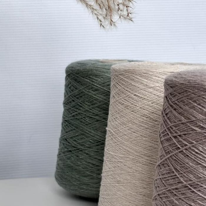 Cones of combed cotton yarn on a creel rack